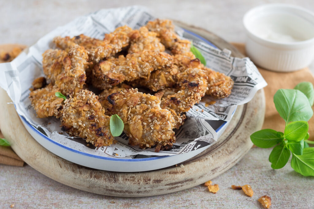 Straccetti di pollo croccanti con cornflakes e sesamo